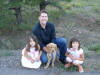 My husband Jeff, our daughters, and our golden retriever puppy, Ollie, September 2004